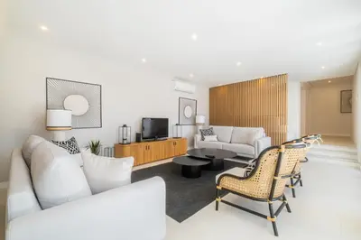 a living room with a couch and a tv at Villa Veiga - Luxury modern design with large beautiful garden in Albufeira
