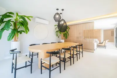 a dining room with a wooden table and chairs at Villa Veiga - Luxury modern design with large beautiful garden in Albufeira