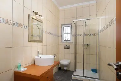 a bathroom with a sink and a shower and a toilet at Casa Coelho in Albufeira