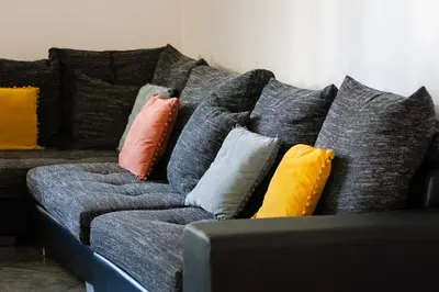 a couch with different colored pillows on it at Casa Coelho in Albufeira