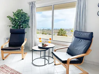 a bedroom with a large bed with blue pillows at Stunning Sunrise & Sunset Rooftop Condo by BeCherish in Albufeira