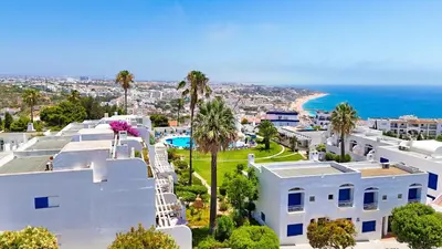an aerial view of a white house and the ocean at Stunning Sunrise & Sunset Rooftop Condo by BeCherish in Albufeira