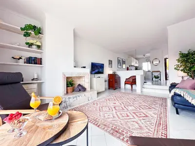 a living room with a table and a couch at Stunning Sunrise & Sunset Rooftop Condo by BeCherish in Albufeira