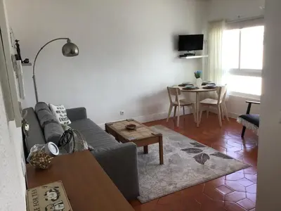 a living room with a couch and a table at Old Town, Bay View Apartment in Albufeira