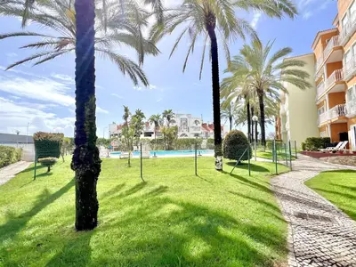 a park with palm trees in front of a building at Albufeira Modern 6 With Pool by Homing in Albufeira