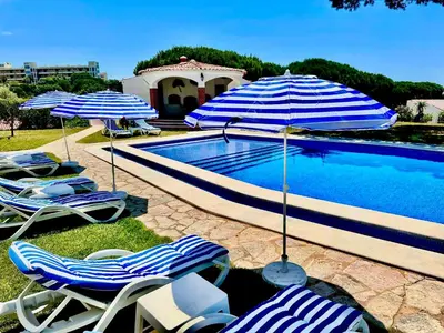 a group of chairs and umbrellas next to a pool at SOLAR Do MONTE 2 in Albufeira