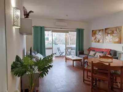a living room with a table and a couch at BeGuest Sea Breeze Apartment in Albufeira