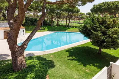 an overhead view of a swimming pool next to a tree at BmyGuest - Vilamoura Golf Villa in Vilamoura