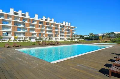a large apartment building with a large swimming pool at Sofisticado Apartamento 3 quartos, terraço privado in Albufeira