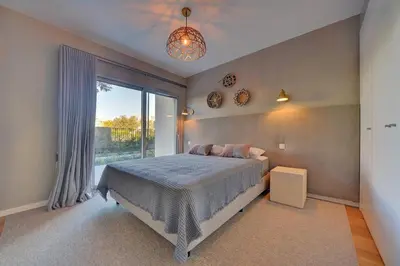 a bedroom with a bed and a large window at Sofisticado Apartamento 3 quartos, terraço privado in Albufeira