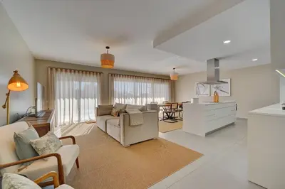 a large living room with a couch and a kitchen at Sofisticado Apartamento 3 quartos, terraço privado in Albufeira