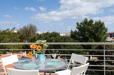 a table and chairs on a balcony with a view at Newly Remodeled 2BD Brilliant Oura Strip 9min beach in Albufeira