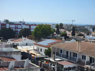 a view of a city with roofs and buildings at Newly Remodeled 2BD Brilliant Oura Strip 9min beach in Albufeira