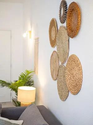 a living room with hats hanging on a wall at Boho house, Albufeira in Albufeira