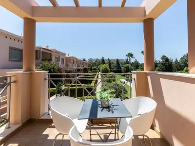 a patio with a table and chairs on a balcony at NEW! Villa Balaia K-11 in Branqueira