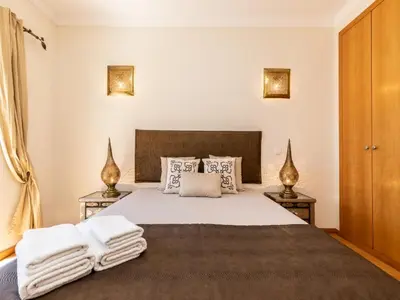 a bedroom with a large bed with towels on it at NEW! Villa Balaia K-11 in Branqueira