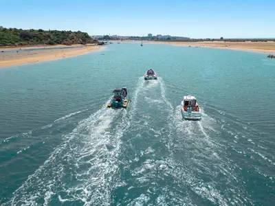 two boats in the water near a beach at Apartment Milos by Algarve Vacation in Albufeira