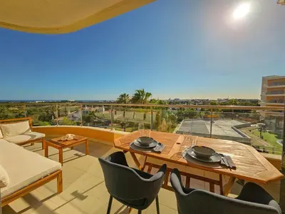 a balcony with a table and chairs and a view at Sea-Stretch viewing SuperKing flat by BentoBox in Albufeira