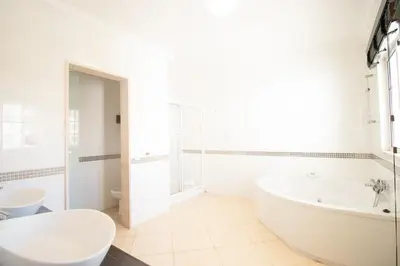 a white bathroom with a tub and a sink at Villa Cinema - Perfect Union in Albufeira