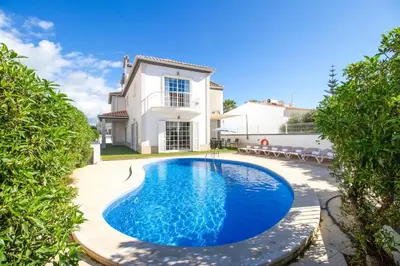 a swimming pool in front of a house at Villa Cinema - Perfect Union in Albufeira