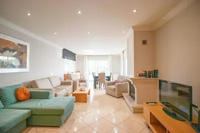 a living room with a couch and a tv at Villa Cinema - Perfect Union in Albufeira