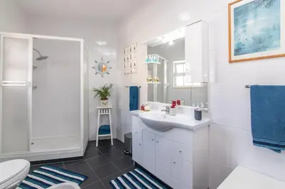 a bathroom with a sink and a shower and a toilet at Villa Mia - Peerless Bond in Albufeira