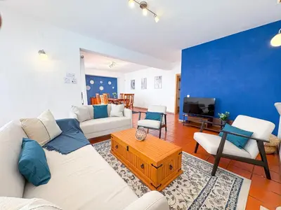 a living room with a white couch and a blue wall at Villa Mia - Peerless Bond in Albufeira