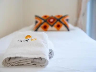 a towel on a bed with astay act sign on it at Oura Sunrise 3B Apartment by Stay ici Algarve Holiday Rental in Albufeira