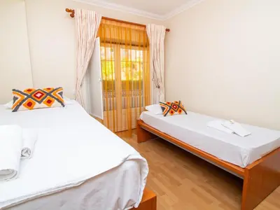 a bedroom with two beds and a window at Oura Sunrise 3B Apartment by Stay ici Algarve Holiday Rental in Albufeira