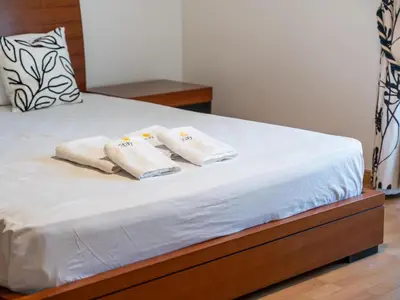 a bedroom with a bed with two towels on it at Oura Sunrise 3B Apartment by Stay ici Algarve Holiday Rental in Albufeira