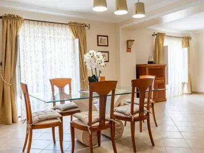 a dining room with a glass table and chairs at Oura Sunrise 3B Apartment by Stay ici Algarve Holiday Rental in Albufeira