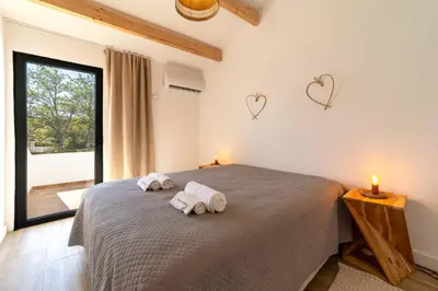 a bedroom with two towels on a bed with two hearts on the wall at Falésia Coast Villa by HelloVacations in Albufeira