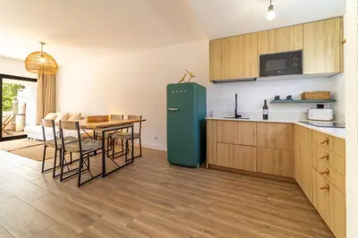 a kitchen with a green refrigerator and a table at Falésia Coast Villa by HelloVacations in Albufeira