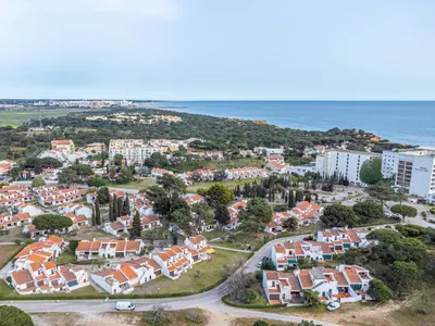 an aerial view of a residential neighborhood next to the ocean at Falésia Coast Villa by HelloVacations in Albufeira