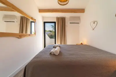 a bedroom with a bed with a towel on it at Falésia Coast Villa by HelloVacations in Albufeira