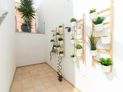 a room with potted plants on the wall at Serenity 03 House by Stay ici Algarve Holiday Rental in Albufeira