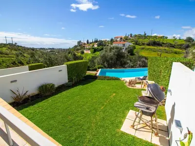 a view of a yard with chairs and a swimming pool at Serenity 03 House by Stay ici Algarve Holiday Rental in Albufeira