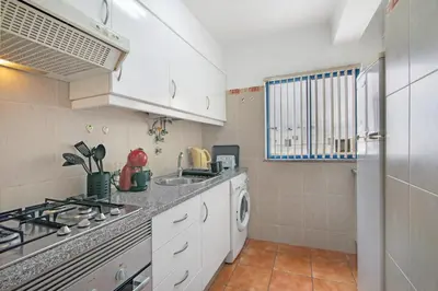 a kitchen with a stove and a sink at T2 2 Linha Praia Vista Mar in Quarteira