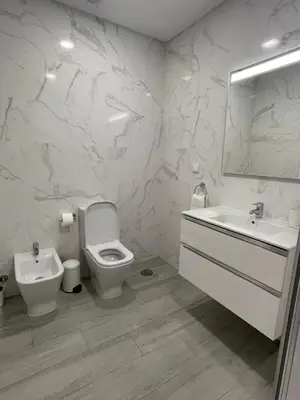 a white bathroom with a toilet and a sink at Apartamento Noronki - Altos do Forte Novo in Quarteira