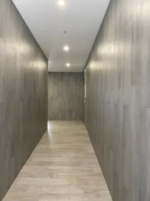 an empty hallway with a wall of wood panels at Apartamento Noronki - Altos do Forte Novo in Quarteira