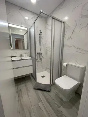 a bathroom with a shower and a toilet and a sink at Apartamento Noronki - Altos do Forte Novo in Quarteira