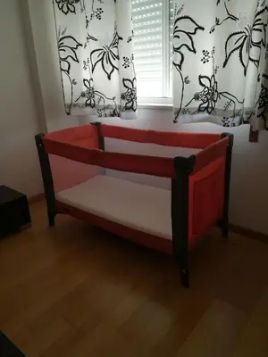 a bed in a room with two windows at Lovely flat in the center in Faro