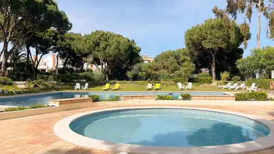 a bedroom with two beds and a lamp on a table at T2 Monte Sol HsRentals Vilamoura in Vilamoura
