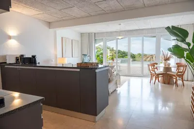 a kitchen and living room with a table and chairs at Apartamento Mare Aveiros Beach in Albufeira