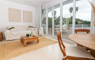a living room with a table and a couch at Apartamento Mare Aveiros Beach in Albufeira