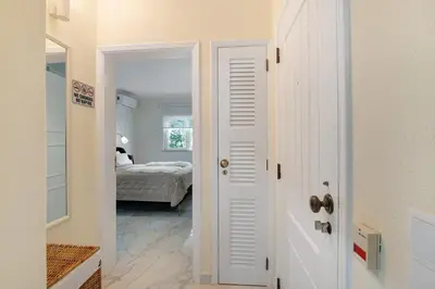 a white door leading to a bedroom with a bed at Celestial Blue Vale Do Lobo in Almancil