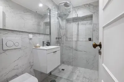 a white bathroom with a shower and a sink at Celestial Blue Vale Do Lobo in Almancil