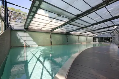 an indoor swimming pool with a glass ceiling at Celestial Blue Vale Do Lobo in Almancil