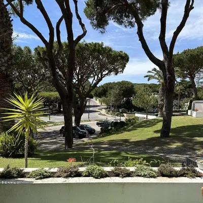 a view of a park with trees and a sidewalk at Celestial Blue Vale Do Lobo in Almancil