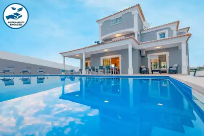 a house with a swimming pool in front of it at Villa Ocean by Algarve Vacation in Albufeira
